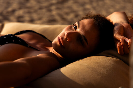 Woman relaxing on the beach during sunset in Colombia