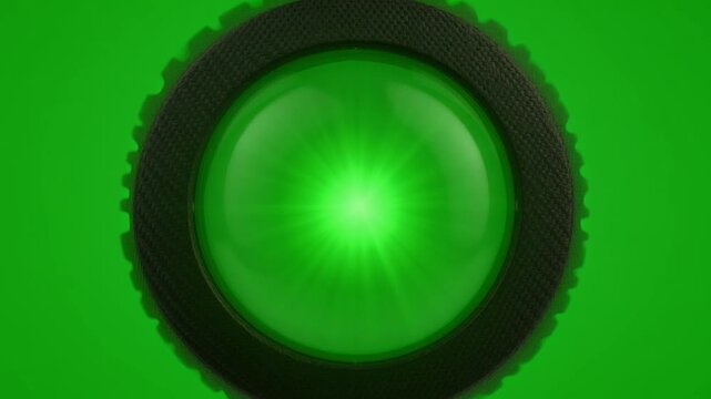 Glowing green button indicator light on green background.