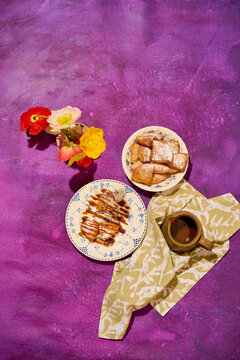 Images of beignets and florals on painted surface