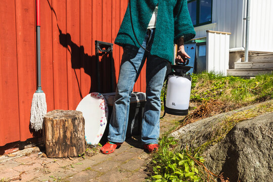 Senior Woman watering Green Sedum Roof