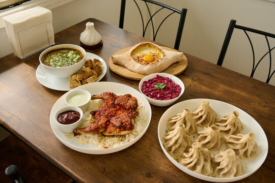 Lunch spread of khachapuri, khinkali, pkhali and chicken georgian food