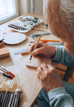 Senior carpenter working with wood.