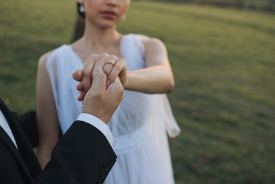 Bride and groom holding hands
Wedding Ring