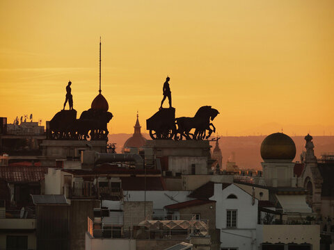 Chariot statues seen on the rooftop of Madrid