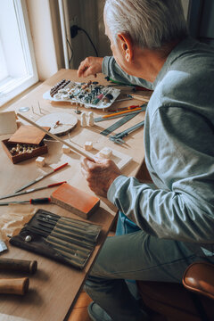 Old Craftsman Working With Wood