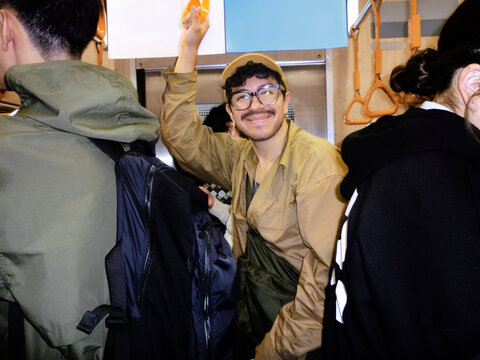 Passenger smiling inside Tokyo public transportation