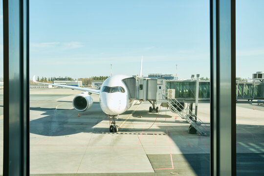 Passenger airplane parked at airport boarding gate