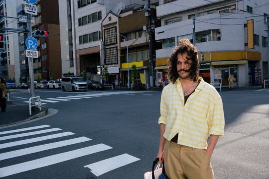 Traveler standing at quiet Tokyo street intersection