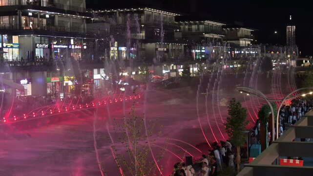Tashkent, Uzbekistan - June 08, 2026: Seoul Mun Street.  Colorful fountain show with spectators enjoying evening performance.