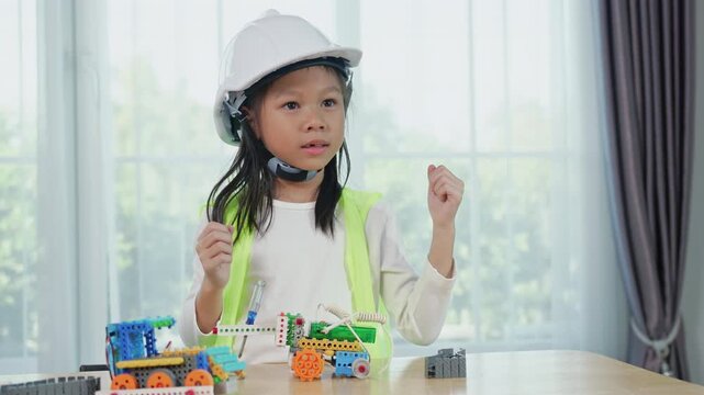 Young girl engineer working on robotics project in a STEM education class. child is focused on assembling and learning about a small robot or electronic project. engineering, innovation, technology.