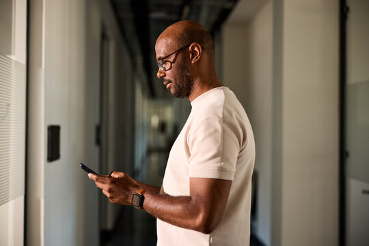 Man sends texts from his phone within the corporation.