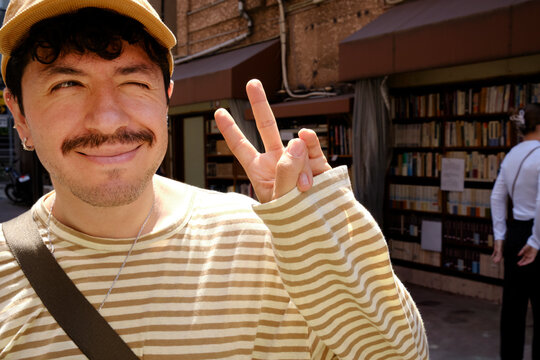 Traveler making peace sign on sunny Tokyo street