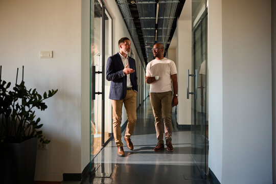 Colleagues chat in the hallway