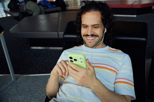 Traveler relaxing with smartphone at Helsinki Airport