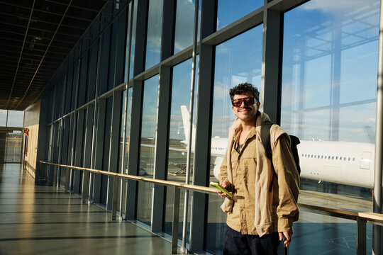 Traveler walking through Helsinki Airport terminal corridor