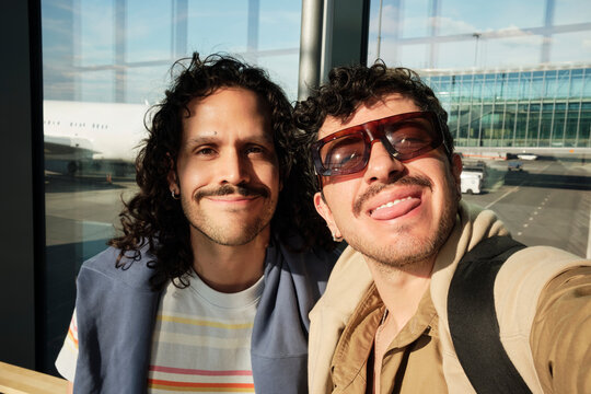 Friends taking selfie at Helsinki Airport terminal