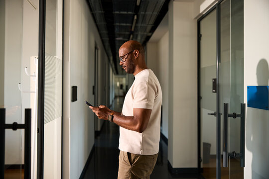 Man send texts via his phone inside the corporation