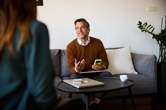 Colleagues talk business in a cozy workspace