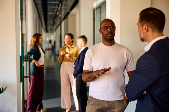 A group of colleagues gathered in the hallway