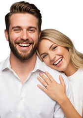 Obraz premium Young caucasian couple in white shirts laughing in a bright studio, blonde woman showing her diamond ring on her hand concept of engagement celebration atmosphere