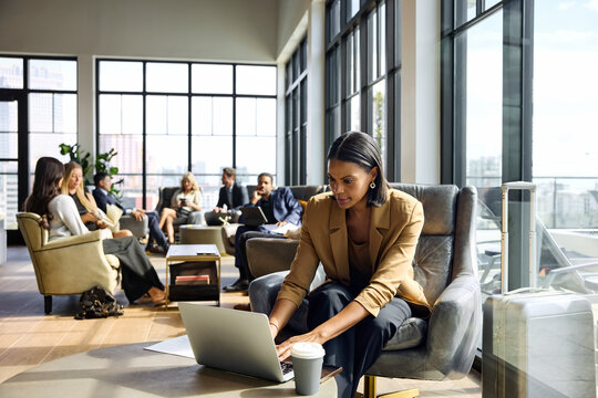 A woman works on a laptop in a modern office