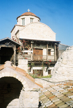 Historic Stone Building With Cross in Clear Sky