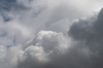 Obraz premium Hopeful clouds with glowing edges. Sunlit clouds cast shadows suggest optimism and depth. Vivid cloud formations accented with light and shadow evoke inspiration and movement