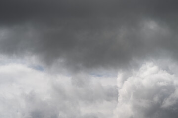 Fototapeta premium Misty gray clouds with subtle light. Heavy overcast clouds featuring textured surfaces and soft glow. Thick brooding clouds with varied textures and gentle illuminated accents
