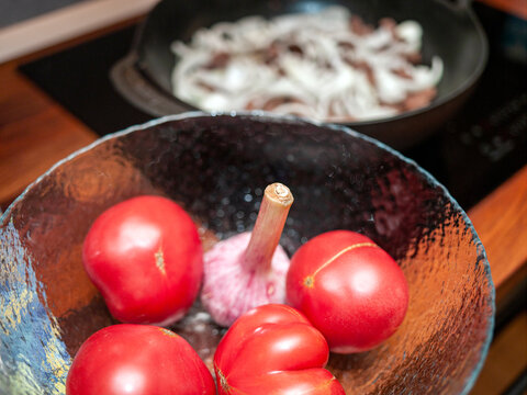 tomatoes and garlic in a glass vase