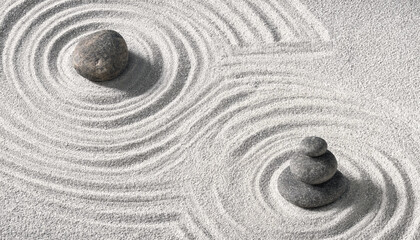 Obraz premium Zen garden sand with raked patterns and stacked stones zen like meditation tranquility minimalist background buddhism spiritual patterns japanese peaceful mindfulness wellness