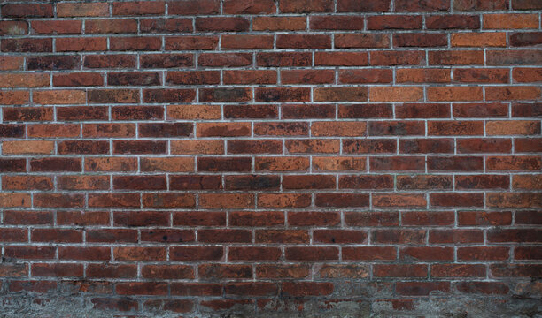 Brown brick masonry wall texture with cement joints. Architectural background for construction, renovation, real estate, design and building materials.