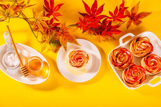 Rose-shaped baked apple dessert on white plate