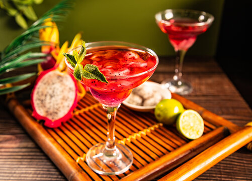 Exotic pitahaya cocktail with lime on bamboo tray