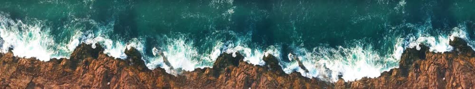 Aerial View of Ocean Waves Crashing on Rocky Coastline, Drone Sea Nature Animation, Widescreen Loop