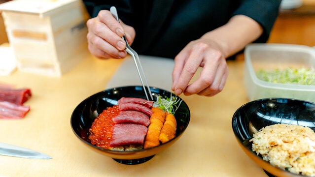Chef plating uni, Miyagi Hon-Maguro and salmon caviar bowl