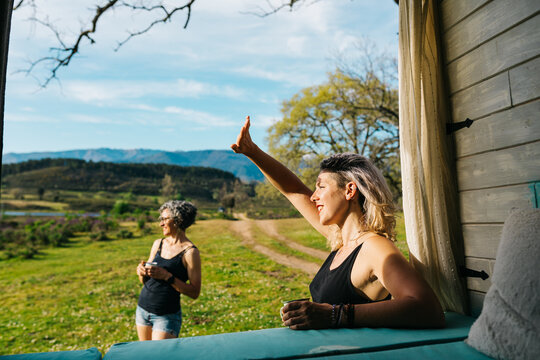 Women enjoying camper holiday view from rustic window