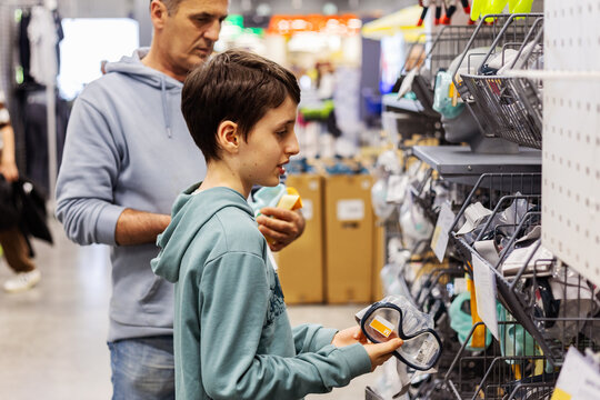 Father and son shopping for sporting goods gear together