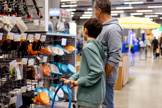 Father and son shopping in sporting goods store