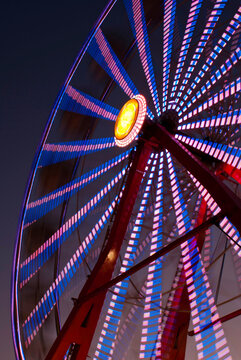 Abstract digital macro of ferris wheel lights at night