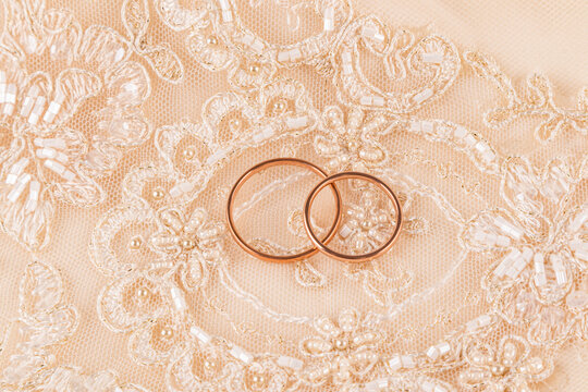 Wedding rings placed on lace fabric representing love