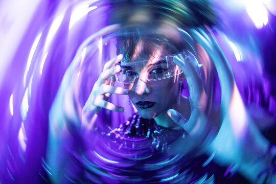 Futuristic cyberpunk woman exploring virtual reality portal