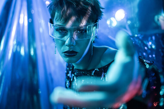 Futuristic cyberpunk woman in virtual reality neon light