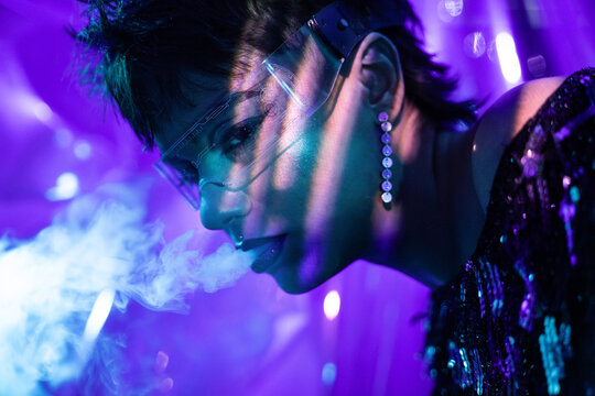 Cyberpunk woman in vr visor with neon smoke portrait
