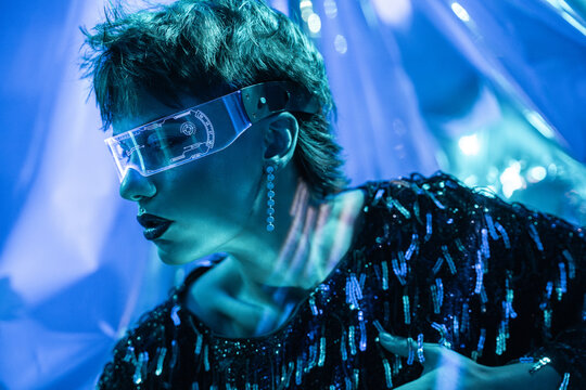 Futuristic cyberpunk young woman in virtual reality visor
