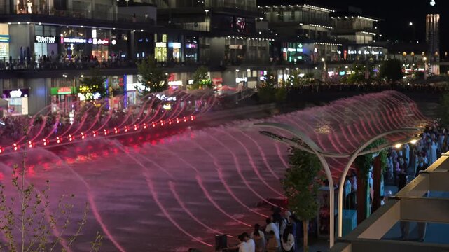 Tashkent, Uzbekistan - June 08, 2026: Seoul Mun Street.  Colorful fountain show with spectators enjoying evening performance.