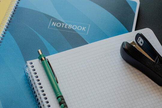 Mechanical pencil and stapler on open spiral notebook