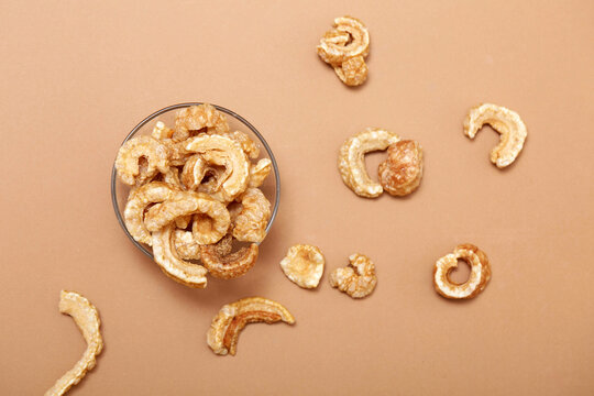 Crispy pork rind tapas snack in bowl on beige background