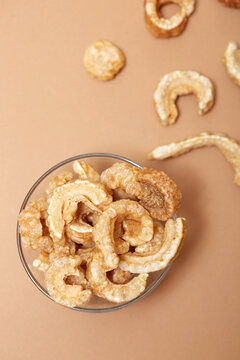 Crispy pork rind tapas snack in bowl on beige background