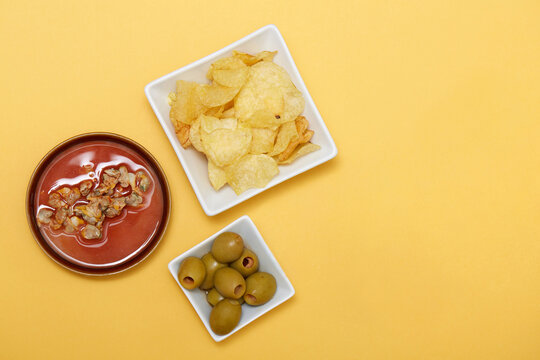 Spanish tapas aperitif with olives chips and seafood dip