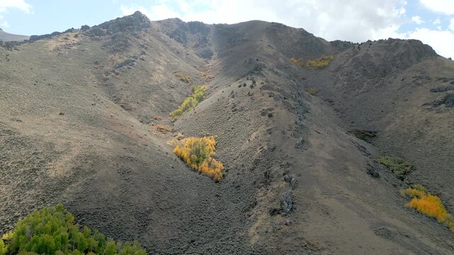 Aerial views of a rocky hillside just outside of Winnemucca Nevada with patches of color in the vegetation.